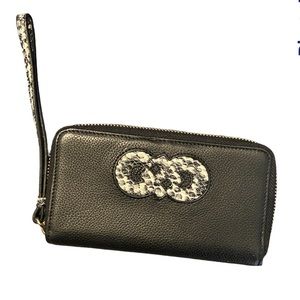 Cole Haan black wristlet with snakeskin print logo and handle